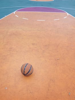 Basketball ball on a outdoor court in public park