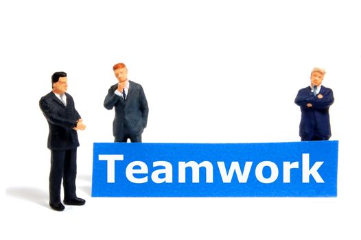 team or teamwork business concept with tiny toy business man isolated on white background