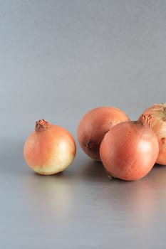 Closeup of few onions on beautiful gray background
