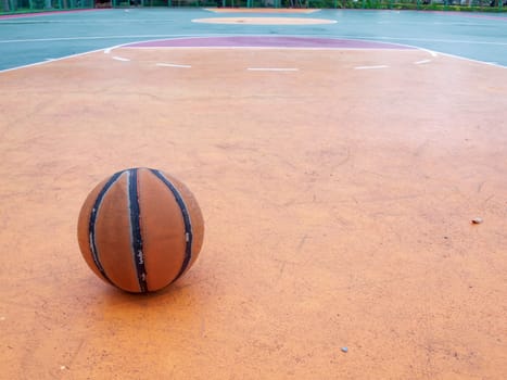 Basketball ball on a outdoor court in public park