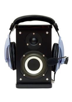 Headphones on a speaker isolated on white. Listening to music and playback.