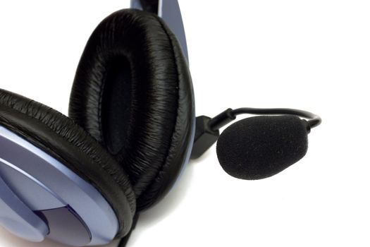 Close up image. Soft black pad of headphones and microphone isolated on white.