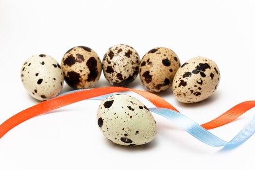 Six quail eggs and two color ribbons