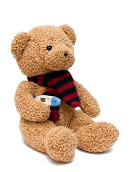 Sick soft toy bear with thermometer under its hand isolated on white.