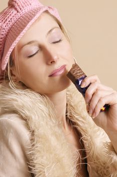 Girl enjoys chocolate bar