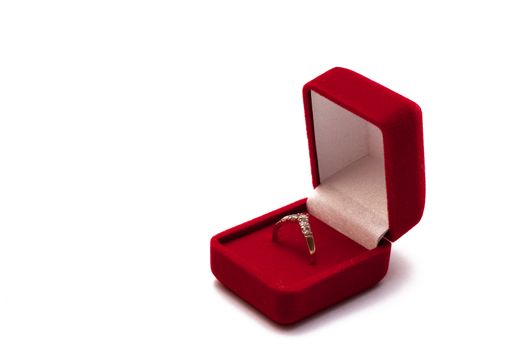 Engagement ring in an open red box isolated on white