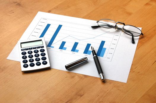 business still life with coffee and chart showing success