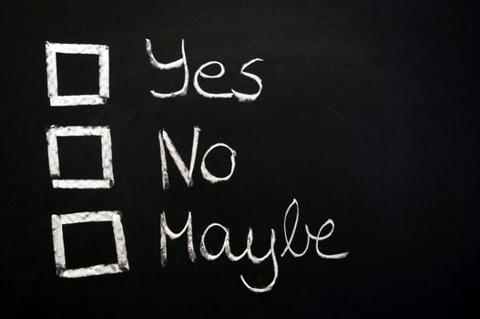 vote yes or no written on chalkboard or blackboard