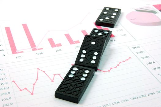 domino over business chart showing the risk of financial or banking crisis