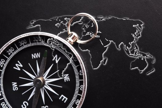world map and compass showing business guidance concept