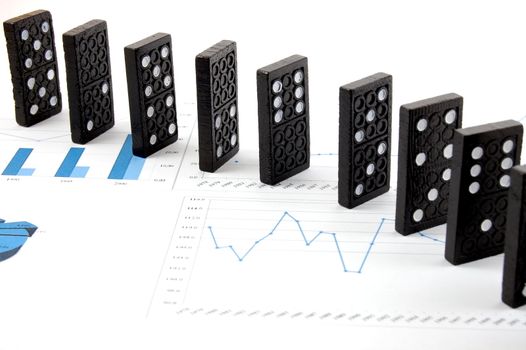 some domino stones on a blue business chart