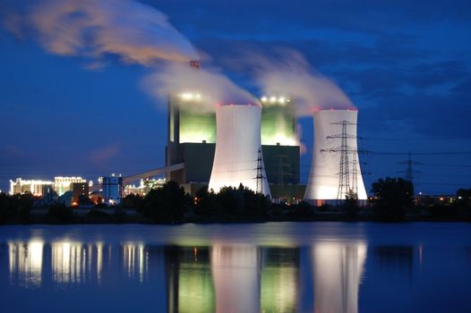 a smoking industrial power plant at night