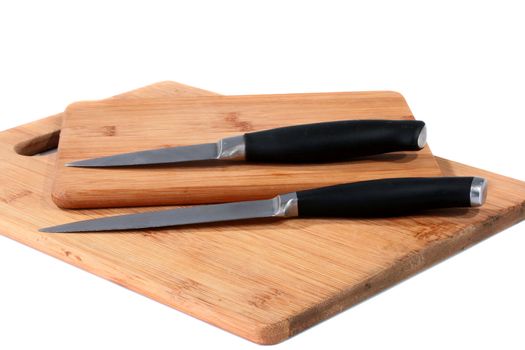 Set from two knifes on bamboo boards for food cutting.