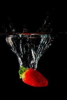 strawberrys splashing in fresh water showing healthy lifestyle