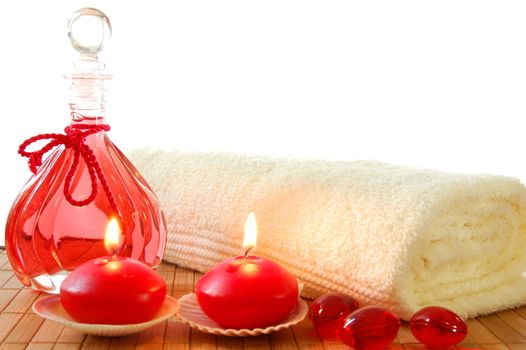 red spa decoration with massage oil bottle and candles