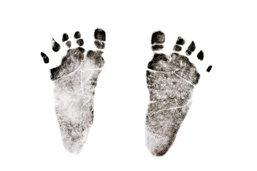 Ink impression of tiny newborn's feet isolated on a white background.