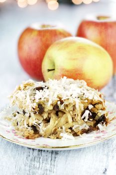 Apple casserole made of shredded apples, oats, coconut and raisins. Shallow depth of field.
