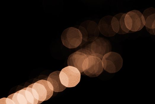 Beautiful yellow blurred spot light arrange in a line.