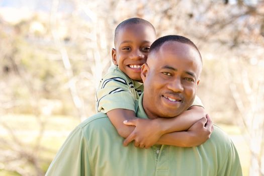 African American Man and Child Having Fun in the Park.