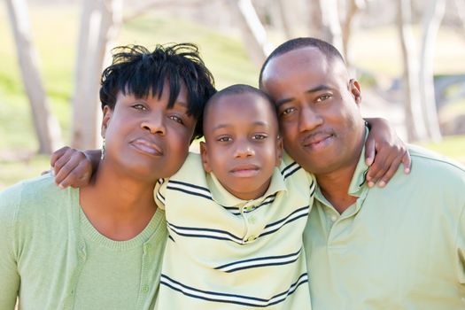 Happy African American Man, Woman and Child Having Fun in the Park.