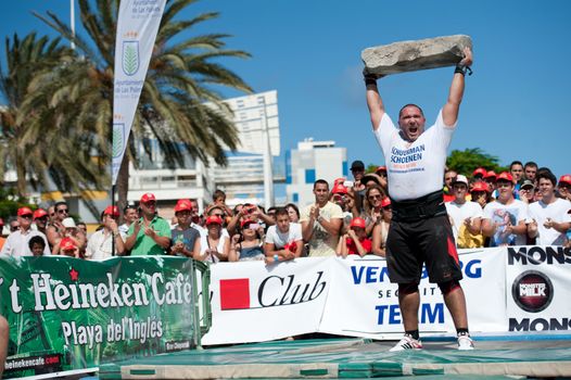 CANARY ISLANDS – SEPTEMBER 03: Akos Nagy from Hungary lifting a heavy stone during Strongman Champions League in Las Palmas September 03, 2011 in Canary Islands, Spain