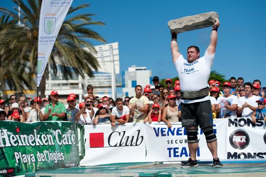 CANARY ISLANDS – SEPTEMBER 03: Jimmy Laureys from Belgium lifting a heavy stone during Strongman Champions League in Las Palmas September 03, 2011 in Canary Islands, Spain