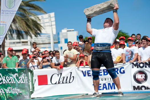 CANARY ISLANDS – SEPTEMBER 03: Lauri Nami from Estonia lifting a heavy stone during Strongman Champions League in Las Palmas September 03, 2011 in Canary Islands, Spain