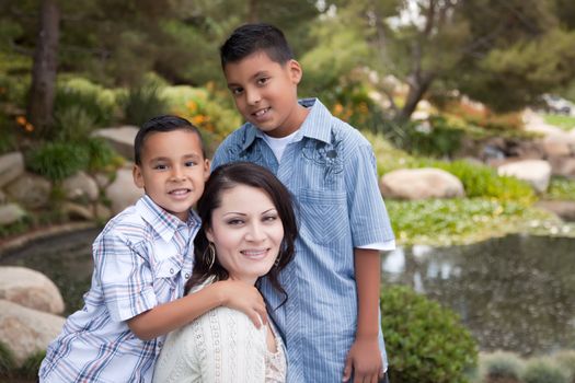 Happy Hispanic Mother and Sons in the Park.