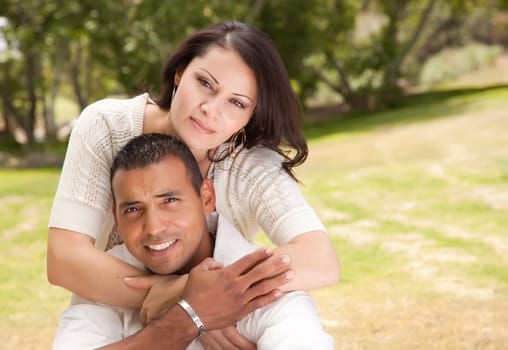 Attractive Hispanic Couple Portrait in the Park.