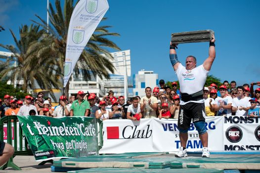 CANARY ISLANDS – SEPTEMBER 03: Juan Carlos Heredia from Spain lifting a heavy stone during Strongman Champions League in Las Palmas September 03, 2011 in Canary Islands, Spain