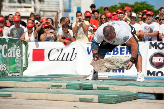 CANARY ISLANDS – SEPTEMBER 03: Juan Carlos Heredia from Spain lifting a heavy stone during Strongman Champions League in Las Palmas September 03, 2011 in Canary Islands, Spain