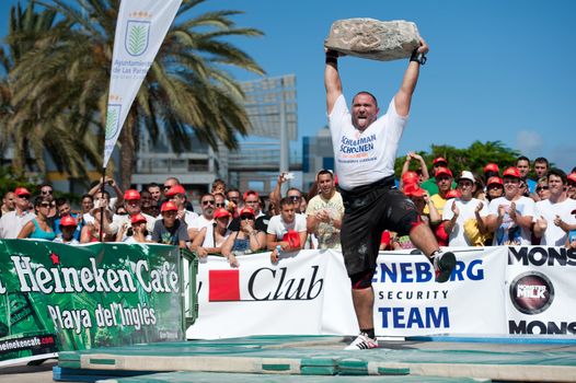 CANARY ISLANDS – SEPTEMBER 03: Akos Nagy from Hungary lifting a heavy stone during Strongman Champions League in Las Palmas September 03, 2011 in Canary Islands, Spain