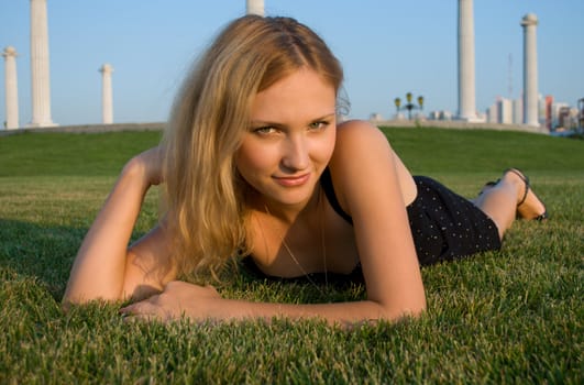 Young pretty woman lying on grass 