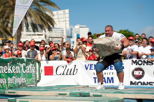 CANARY ISLANDS – SEPTEMBER 03: Juan Carlos Heredia from Spain lifting a heavy stone during Strongman Champions League in Las Palmas September 03, 2011 in Canary Islands, Spain