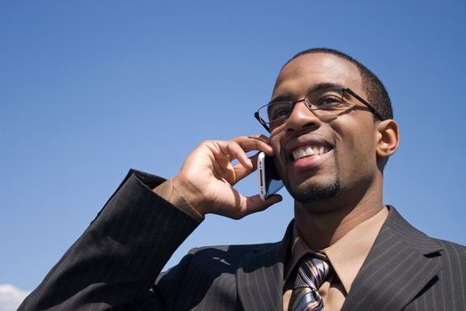 A young business man talking on his cell phone where he has service.