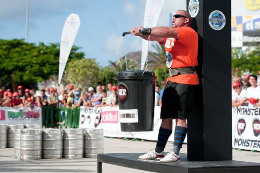 CANARY ISLANDS - SEPTEMBER 03: Ervin Katona from Serbia lifting a heavy trash can for longest possible time during Strongman Champions League in Las Palmas September 03, 2011 in Canary Islands, Spain