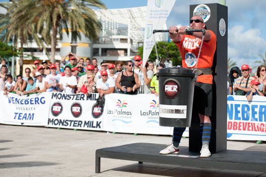 CANARY ISLANDS - SEPTEMBER 03: Ervin Katona from Serbia lifting a heavy trash can for longest possible time during Strongman Champions League in Las Palmas September 03, 2011 in Canary Islands, Spain