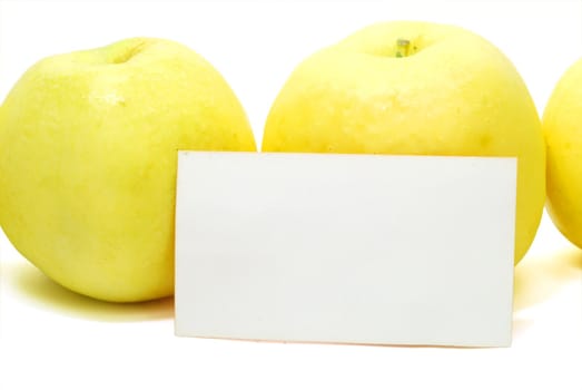 Two Yellow Apples with Blank Advertisement Card Isolated on White