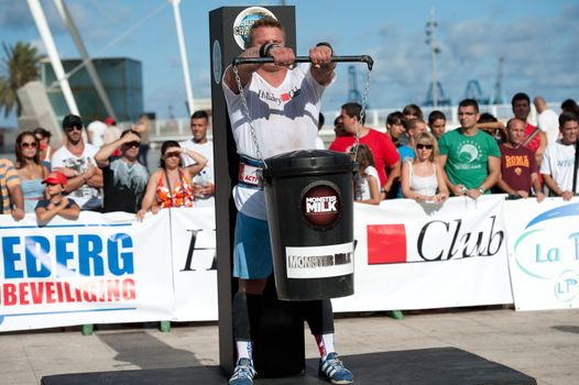 CANARY ISLANDS - SEPTEMBER 03: Tomi Lotta from Finland  lifting a heavy trash can for longest possible time during Strongman Champions League in Las Palmas September 03, 2011 in Canary Islands, Spain
