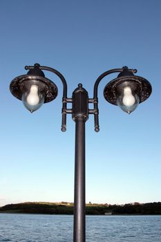 irish street light isolated on blue sky and sea background with clipping path