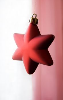 Decorative Christmas star over white and pink background