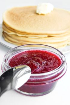 Plate of jam and pancakes with butter