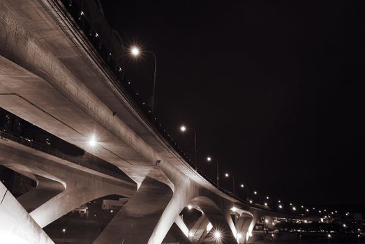 Cityscape of bridge with dark sky in the evening.