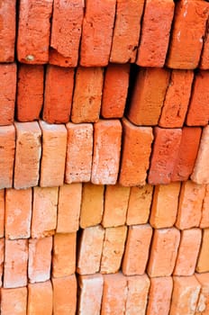 A beautifully stacked red and rust colored bricks.