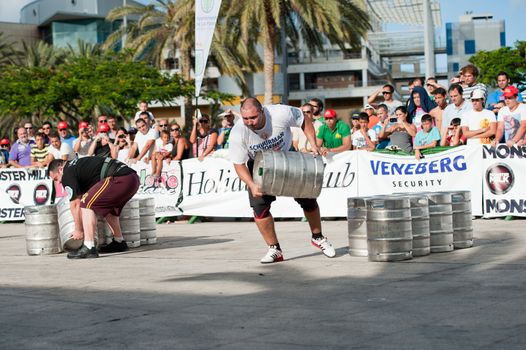 CANARY ISLANDS-SEPTEMBER 03: Julio Jimenez Zancajo(r) and Alex Curletto(l) lifting and running with a barrel during Strongman Champions League in Las Palmas September 03, 2011 in Canary Islands, Spain