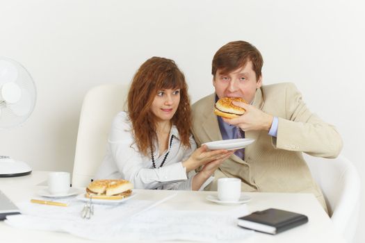 Young men have dinner at office on a workplace