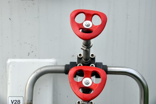 Red handles on valves of the pipeline