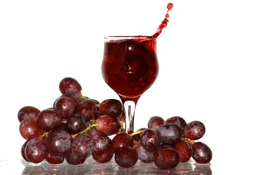 Goblet of red wine and grapes bunch isolated on white with clipping path