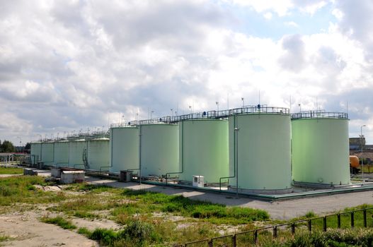 Greater green fuel tanks on a background of clouds