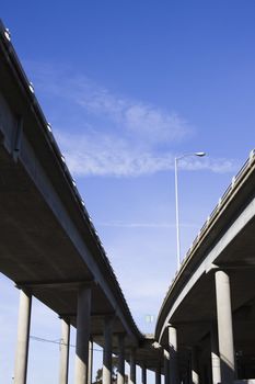 Contrasting Pillars of a Highway Overpass With a Bright Blue Sky